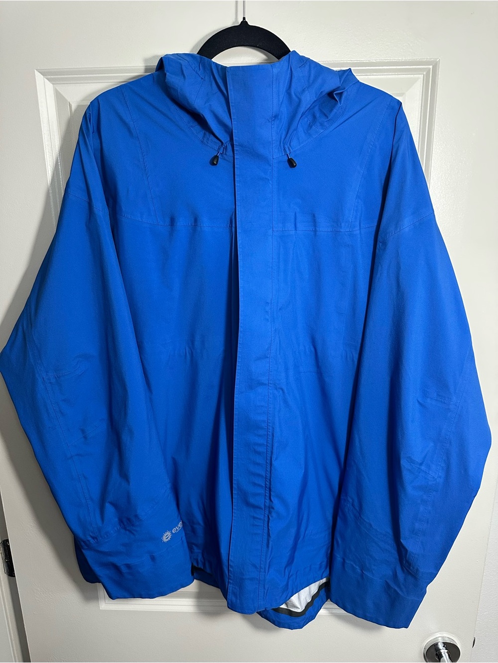 REI Co-op technical rain jacket in a bright blue colorway